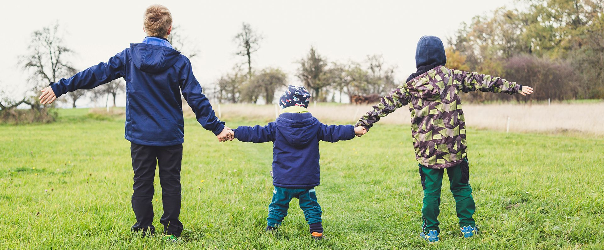 children holding hands outside