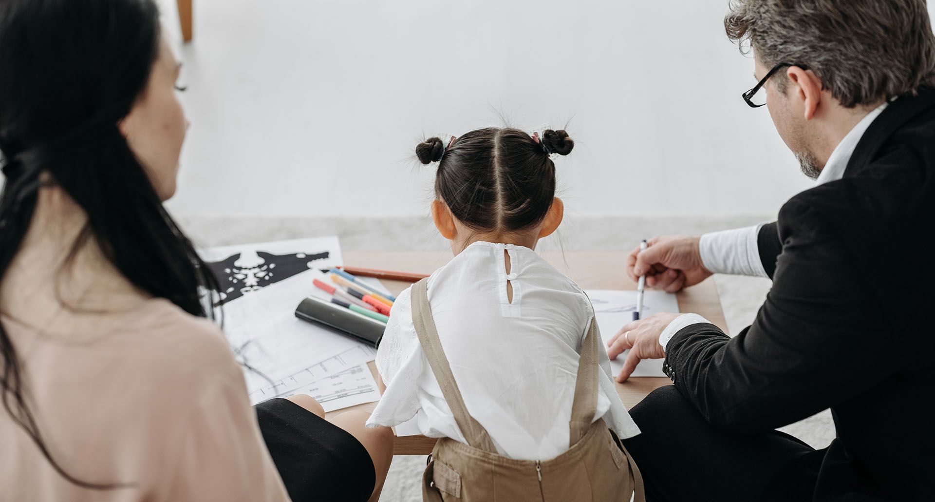 parents with child sitting at table