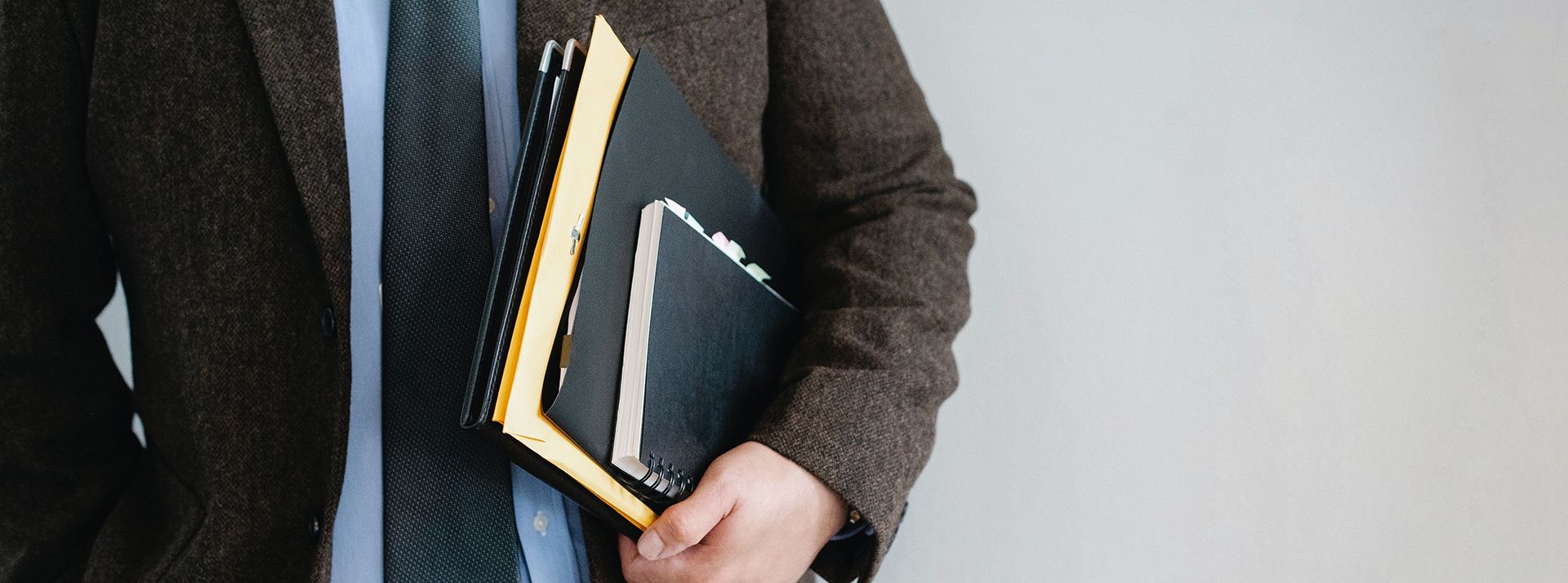 man in suit with files