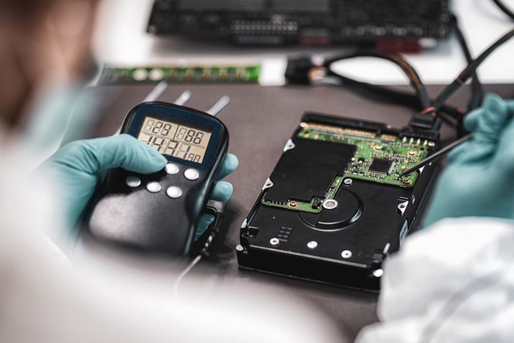 Digital Forensic Science. Police Forensic Analyst Examining Computer Hard Drive.