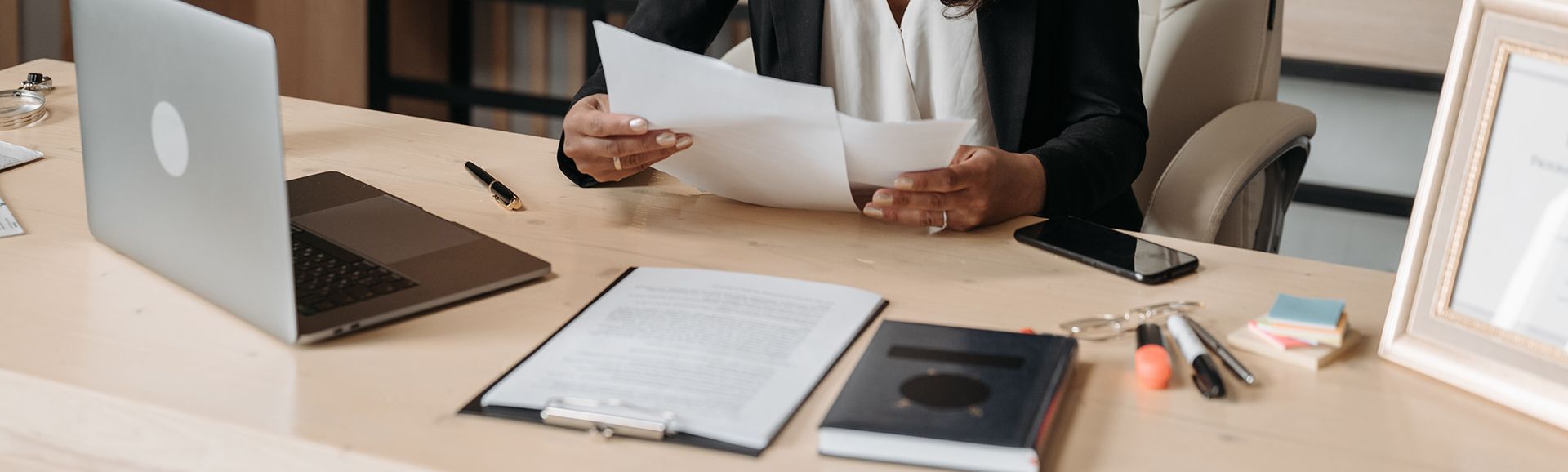 person reviewing paperwork at desk