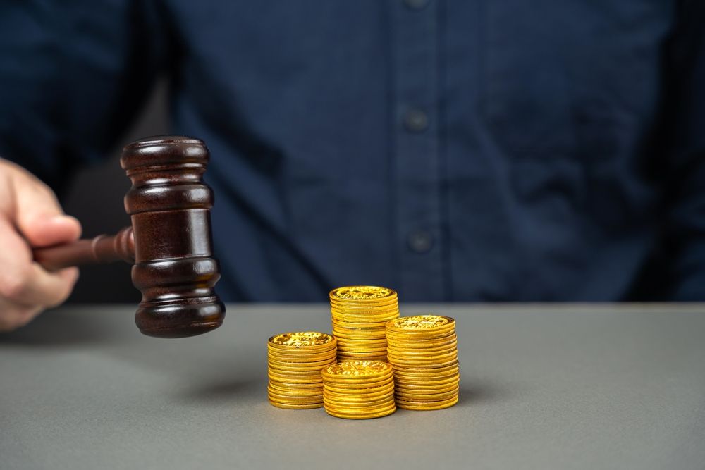 Judge's gavel and stack of coins