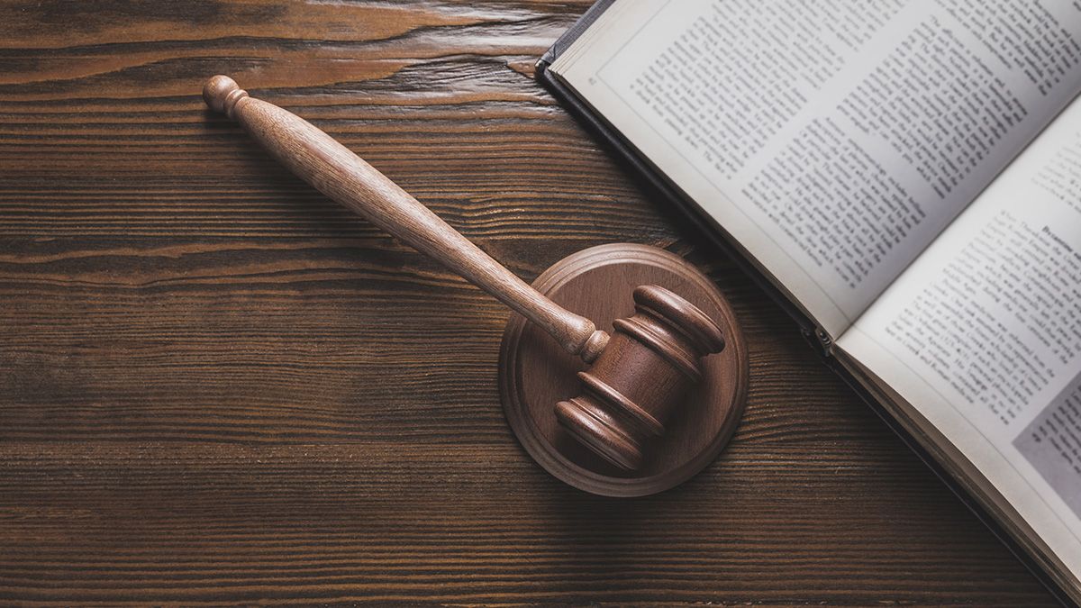 
                    gavel and open law book on table