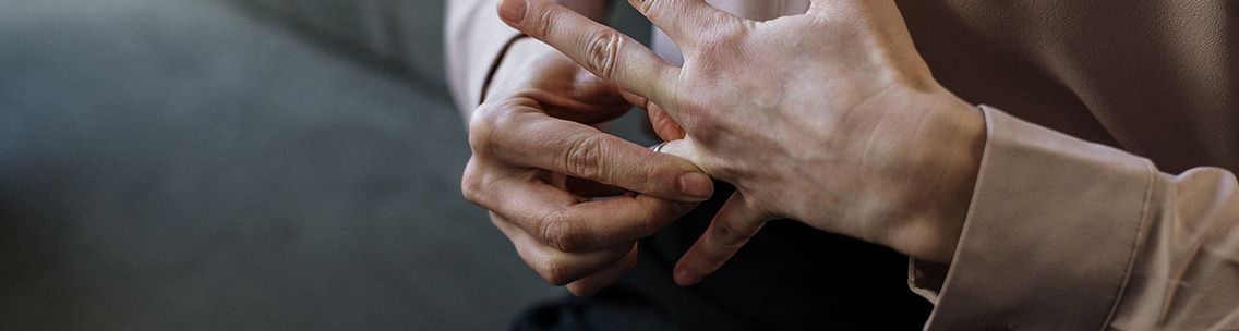 person taking wedding ring off