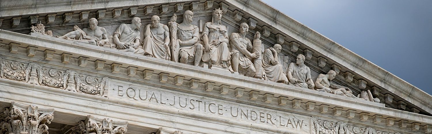 Sculpted eve of US Supreme Court Courthouse Portico with Equal Justice Under Law written beneath it