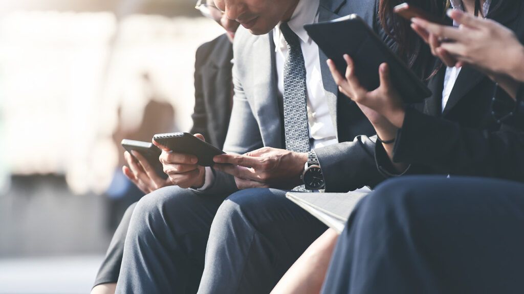 closeup of business professionals texting on their phones