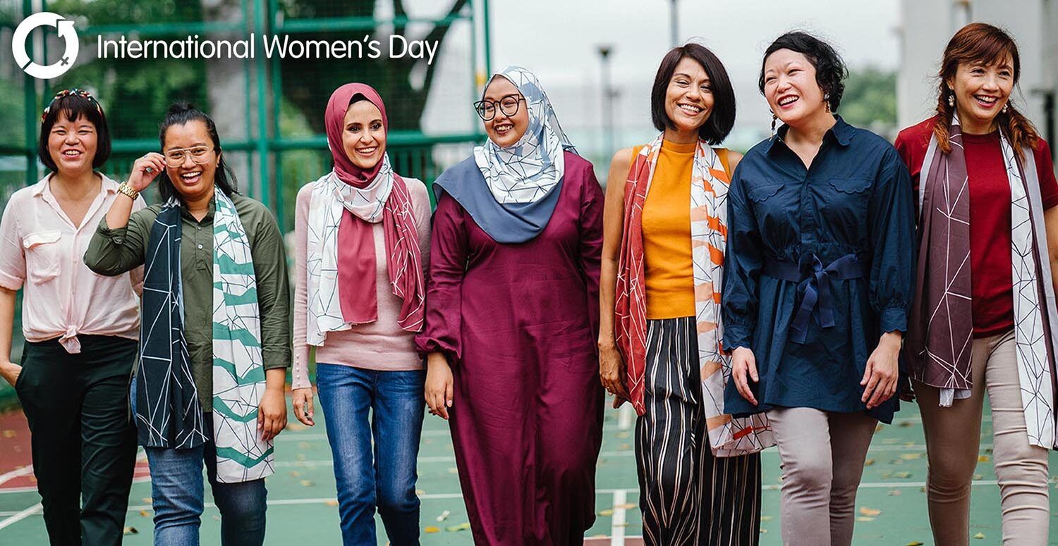 
                    A group of racially and ethnically diverse women walk together happily