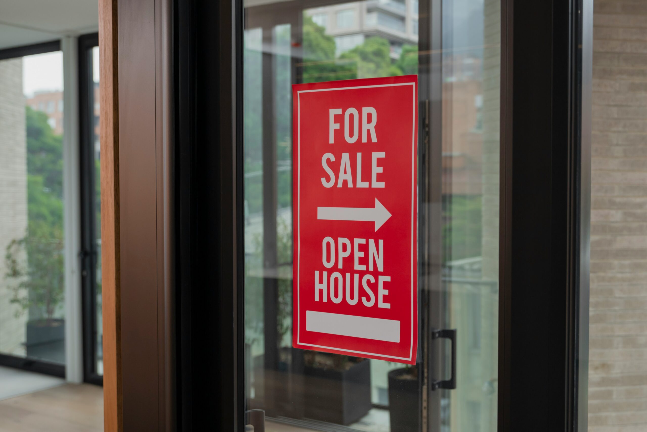A sign reading "For Sale" is displayed on a closed door, indicating the property is available for purchase.