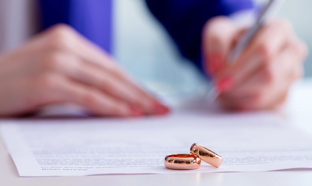 Woman signing prenuptial agreement in court